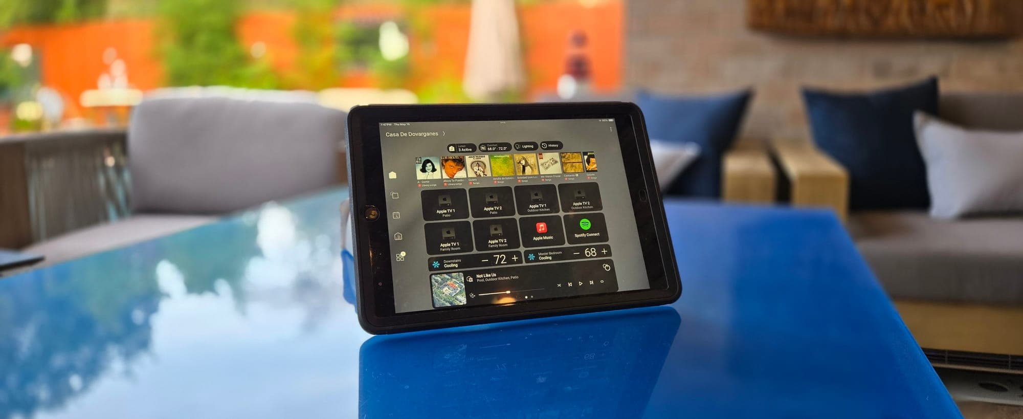 Tablet running the whole-home control app on a poolside table